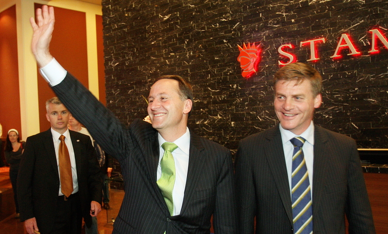 New Zealand Prime Minister-elect John Key (C) waves to supporters with his deputy Bill English (R) after attending a press conference, in Auckland on November 9, 2008. Key's National Party sweep the Labour government led by Helen Clark aside in an election held on November 8 and Clark announced she would step down as leader of the party AFP PHOTO/William WEST / AFP PHOTO / WILLIAM WEST