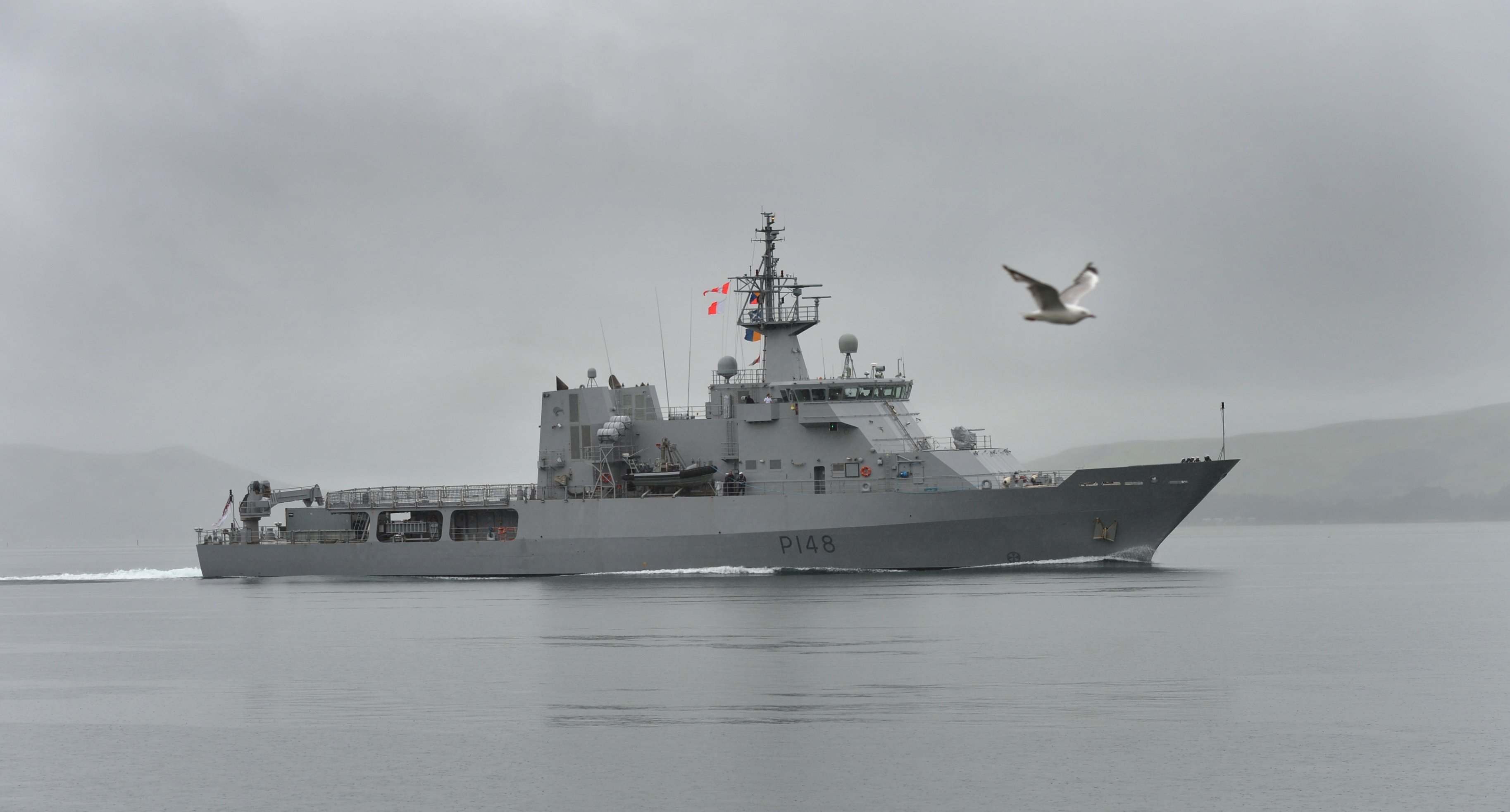 Grey welcome . . . the HMNZS Otago steams up the lower harbour on Thursday morning.